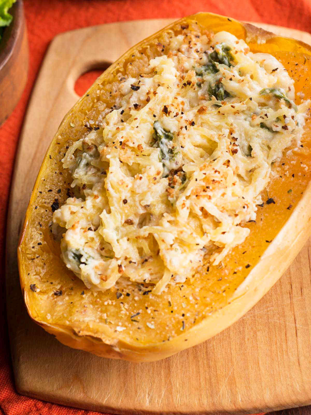 Spaghetti squash pasta topped with creamy pasta sauce and herbs.