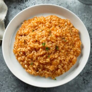 Tomato risotto on a plate.