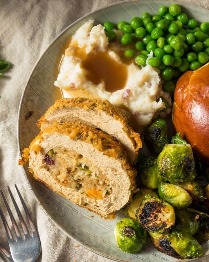 Plat with tofu roast, mashed potatoes, brussels sprouts and dinner rool