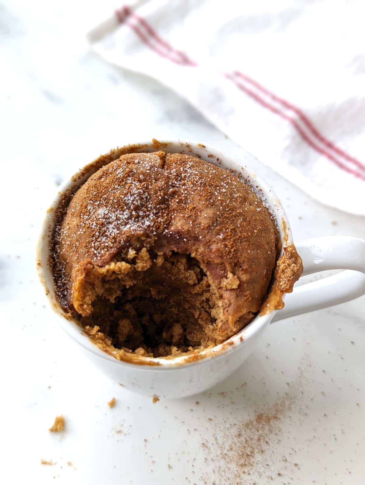 A bite missing from the snickerdoodle mug cake.