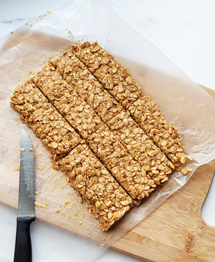 Just 5 ingredients and 5 minutes to whip these up. These bars are so easy to make, you'll never buy store-bought granola bars again. They are very filling, boasting 9g of protein using only whole food ingredients, and are vegan and gluten free! #granolabar #vegansnack #easysnack #vegan #glutenfree #healthysnack