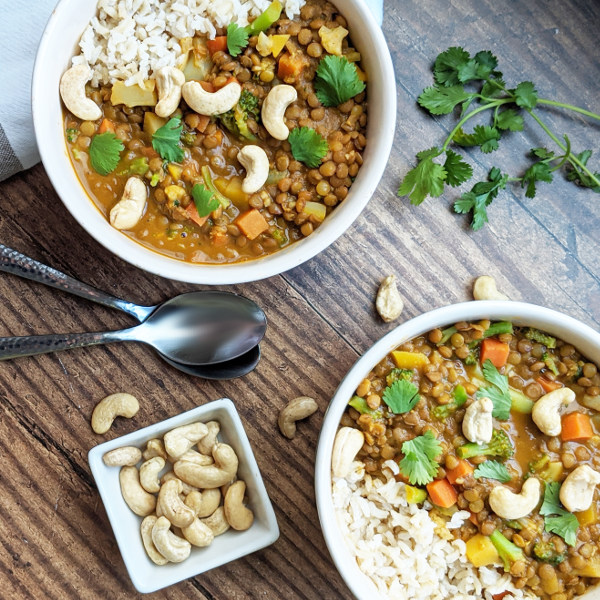 The EASIEST Vegan One-Pot Coconut Lentil Curry! Just 7 main ingredients needed. Makes a ton which is perfect for meal prep! Only requires mostly pantry and freezer friendly ingredients. #vegan #curry #mealprep #vegancurry #plantbased #coconutcurry #lentilcurry #veganrecipe #easyveganmeal #oilfree #glutenfree