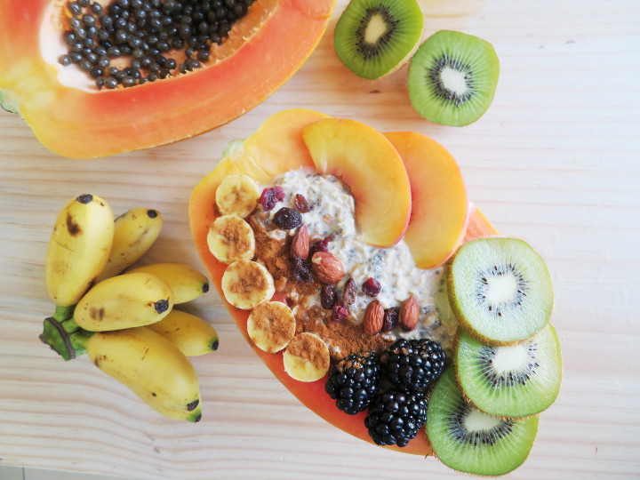 Papaya boats are a delicious and fun way to eat papayas. Fill your papaya up with overnight oats and fresh fruit for a truly tasty and filling breakfast. It's also easy to make and incredibly healthy! This breakfast is a delicious whole food plant based vegan breakfast or snack. #papaya #veganbreakfast #breakfastbowl #healthybreakfast #glutenfree #brunchrecipe #vegan #plantbased 