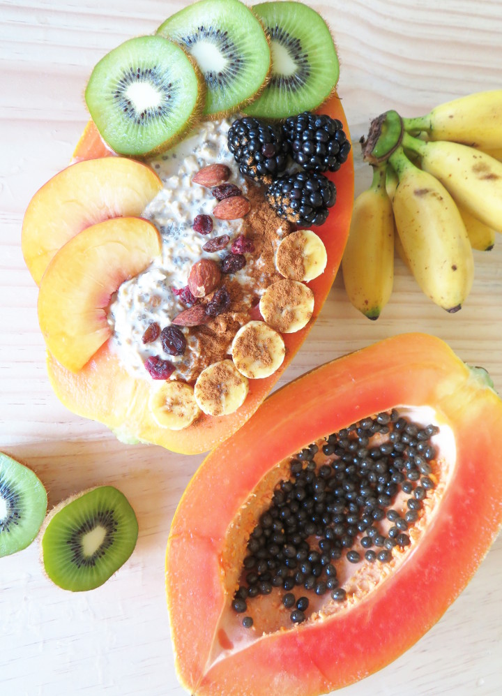 Papaya boats are a delicious and fun way to eat papayas. Fill your papaya up with overnight oats and fresh fruit for a truly tasty and filling breakfast. It's also easy to make and incredibly healthy! This breakfast is a delicious whole food plant based vegan breakfast or snack. #papaya #veganbreakfast #breakfastbowl #healthybreakfast #glutenfree #brunchrecipe #vegan #plantbased 