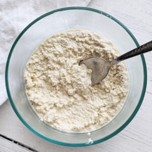 Quick and easy vegan ricotta made with cashews! No oil or soy. It's sweet and tangy--the perfect replacement for dairy ricotta. Healthy, easy, and delicious! Use as a dip, in lasagna, stuffed shells, spread on toast or crackers or add on top of salads! #vegancheese #cashewricotta #dairyfree #cashewcheese #plantbasedcheese