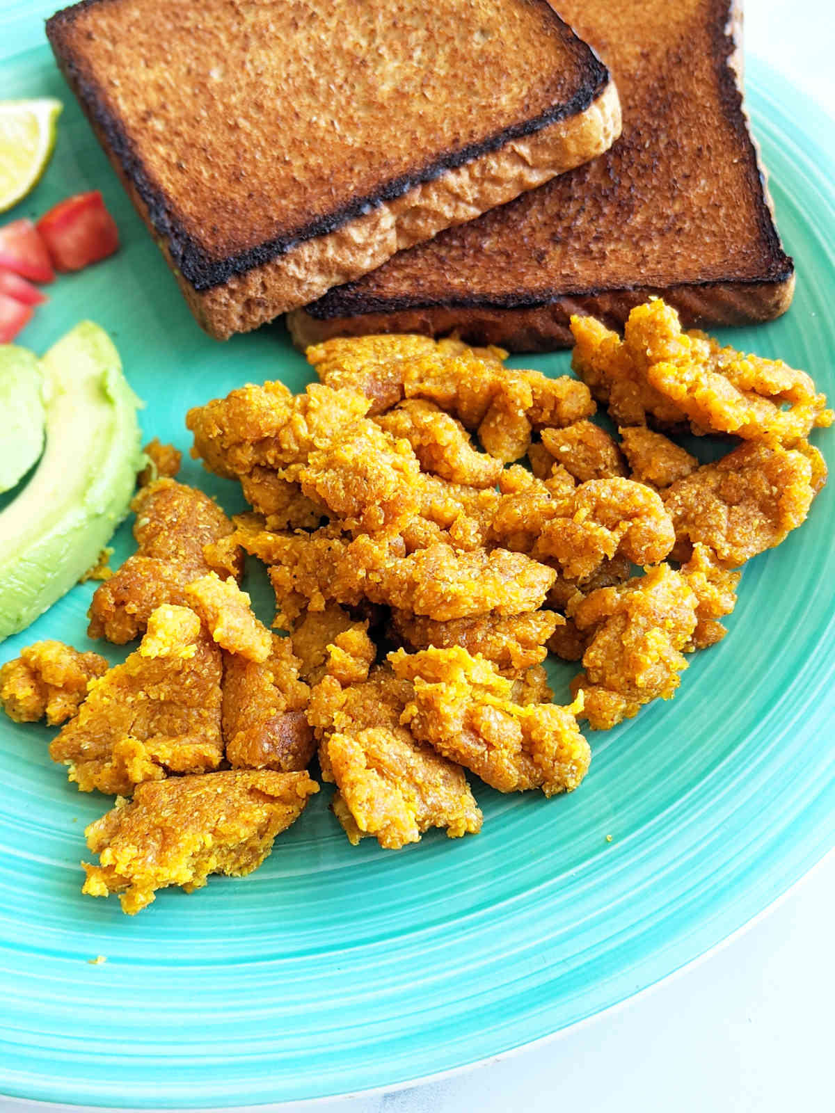 Chickpea flour scramble on a plate with a side of toast.