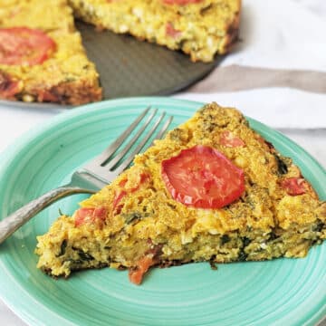 Chickpea flour frittata slice on a plate with a fork