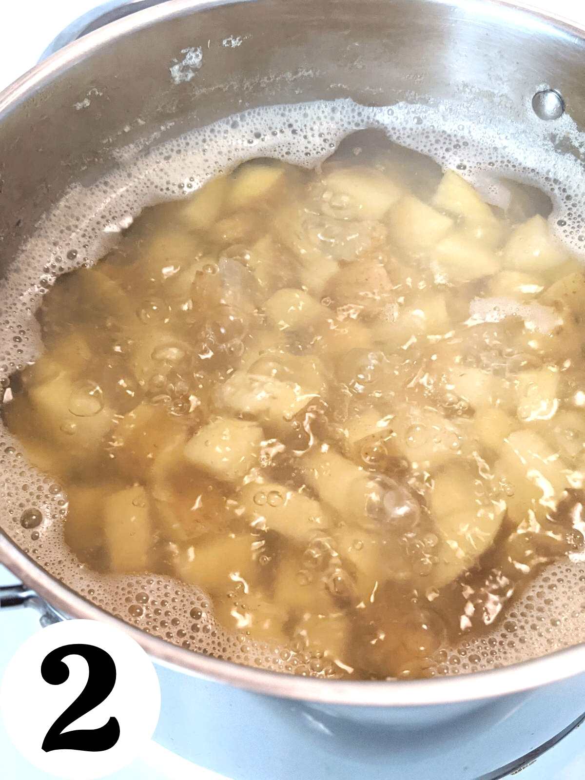Boiling potatoes in pan.