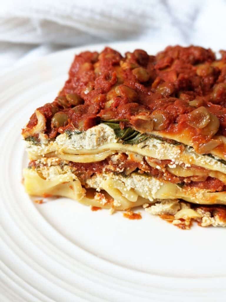 A slice of vegan lasagna served on a plate.
