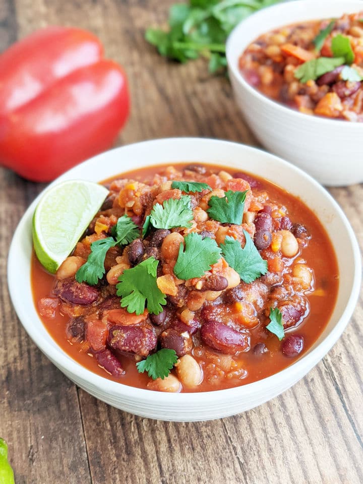 Bowl of finished chili topped with cilantro and a lime wedge