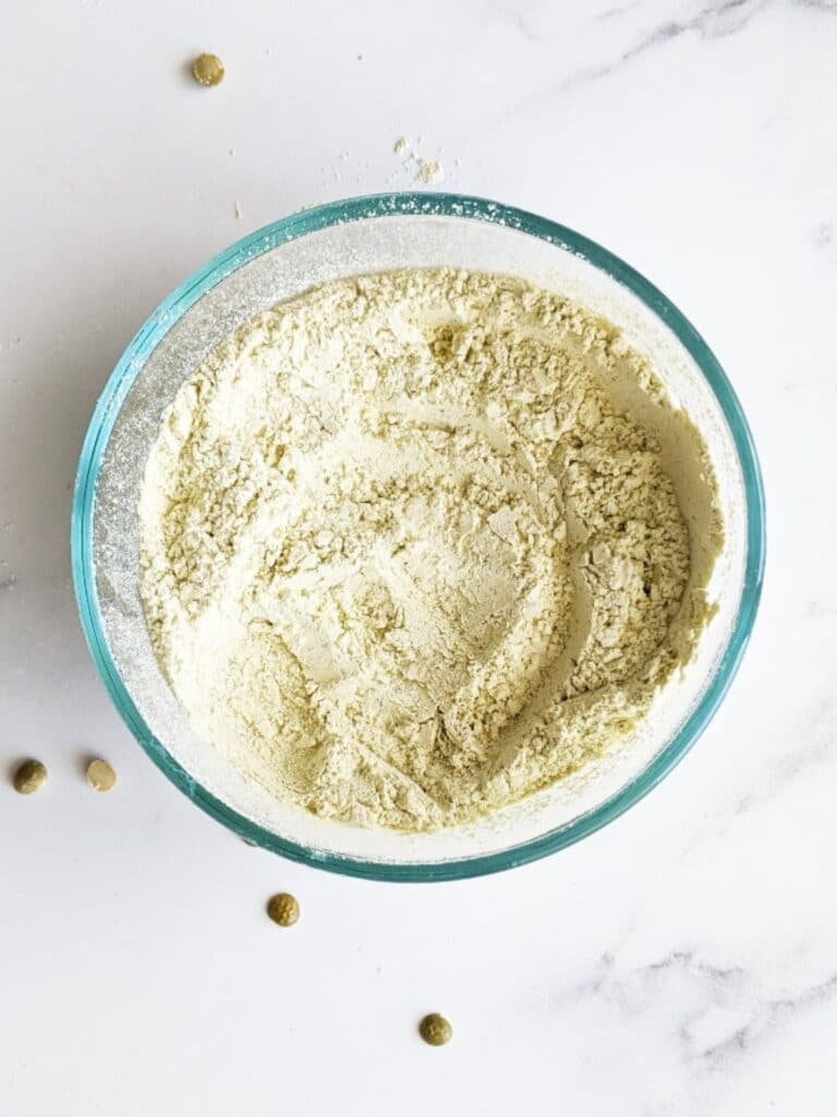 homemade protein powder in a bowl with split peas around it