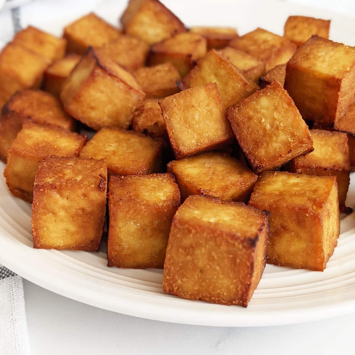 Crispy air fried tofu on a plate