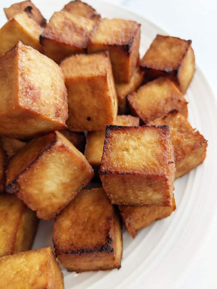 Up close image of crispy cube tofu on a plate