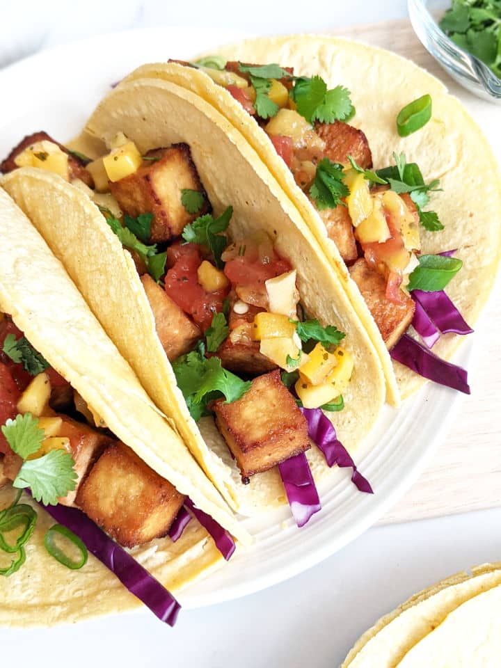 Up close of assembled tofu tacos on a plate