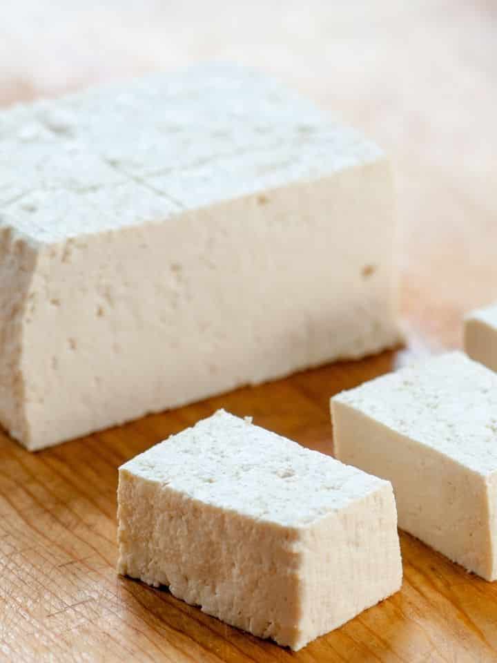 Extra firm tofu on a cutting board