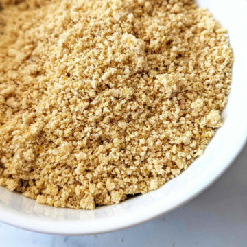 Vegan parmesan made with cashews and nutritional yeast in a small bowl.