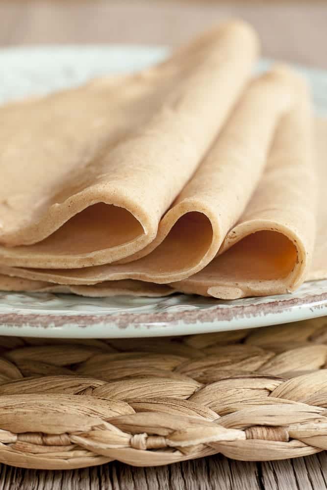 Folded tortillas on a plate.