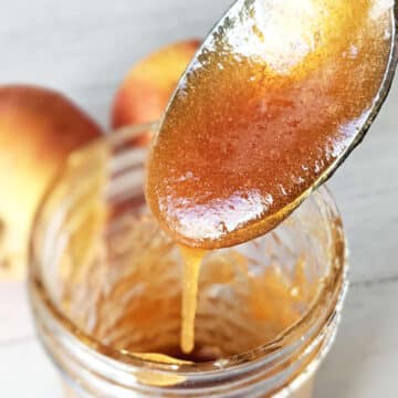 Vegan apple honey dripping off spoon.