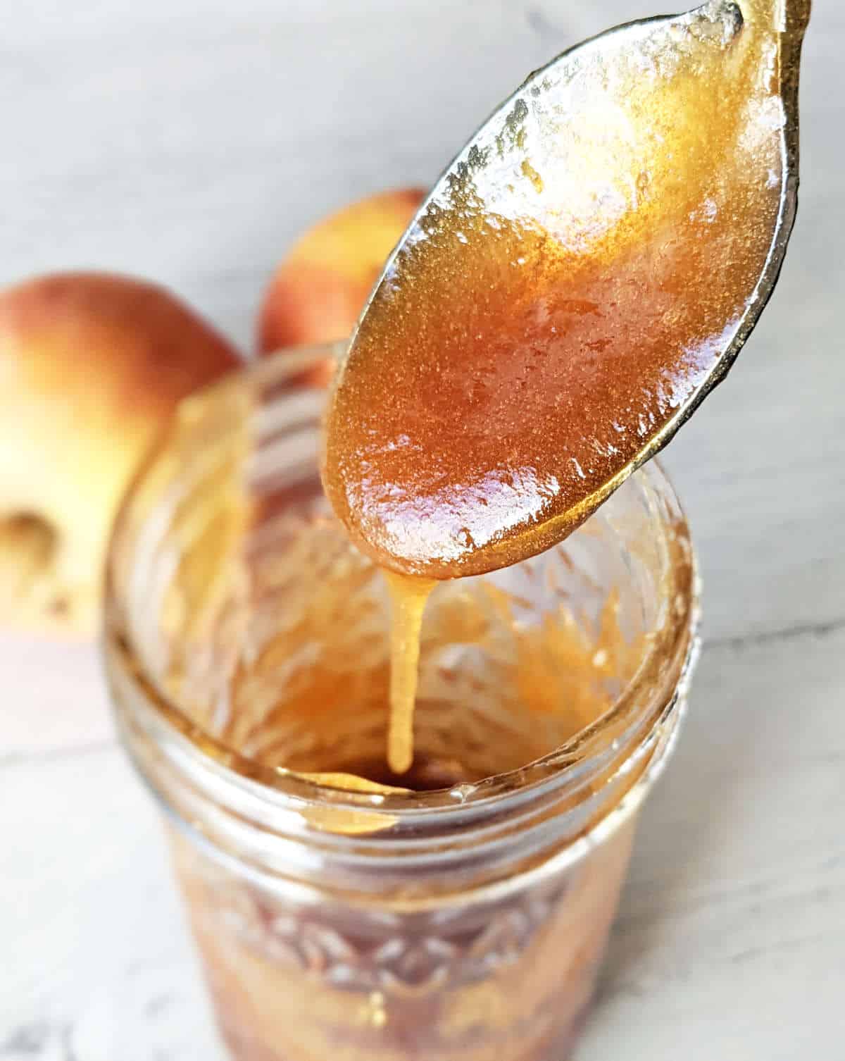 Apple honey dripping off a spoon.