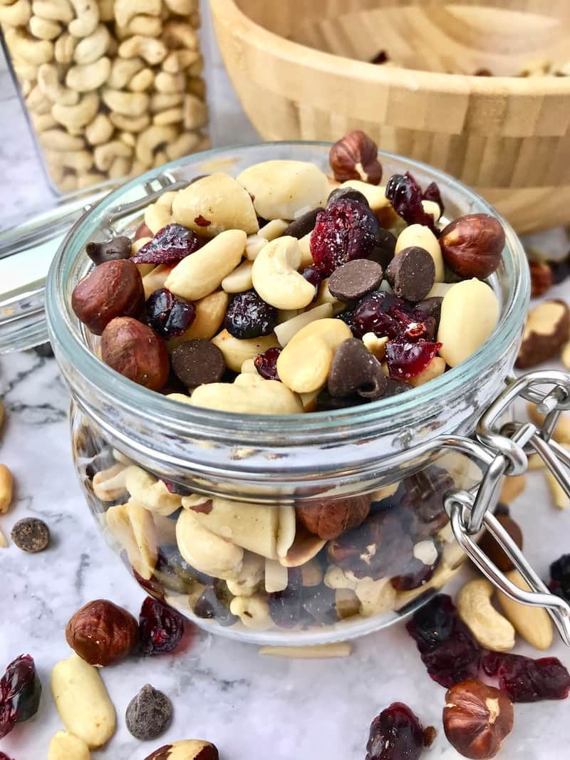 Glass jar filled with vegan trail mix.