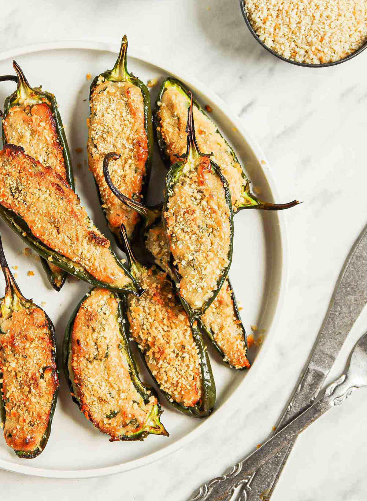 Vegan jalapeno poppers on a serving platter.