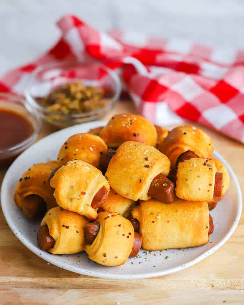 Vegan pigs in a blanket served on a plate.