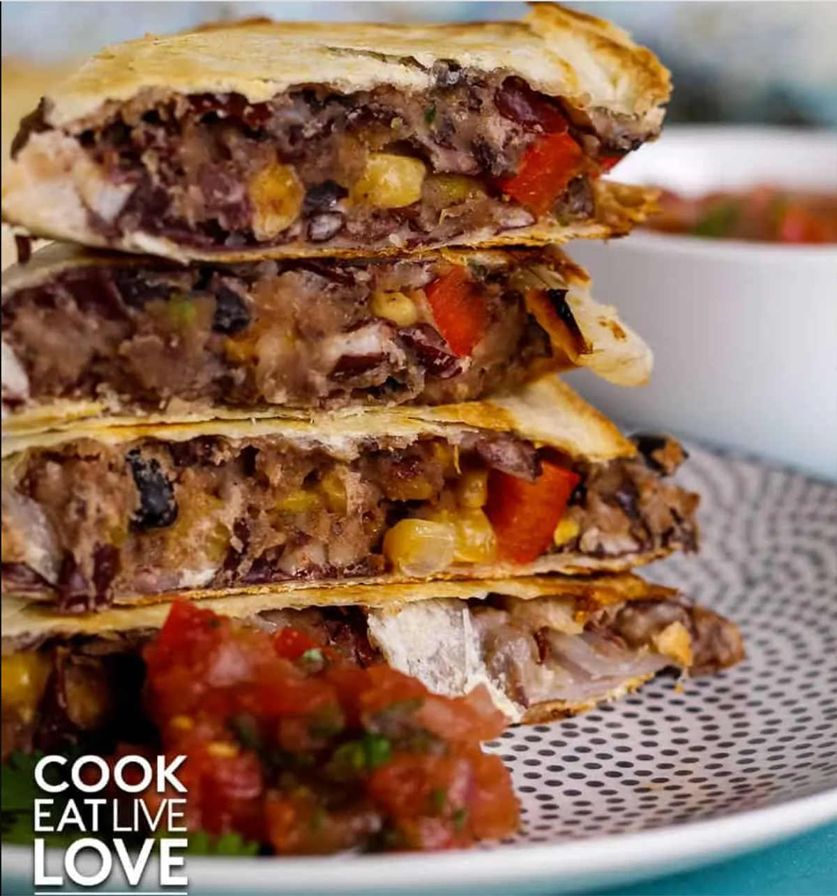 Vegan quesadillas stacked on a plate.