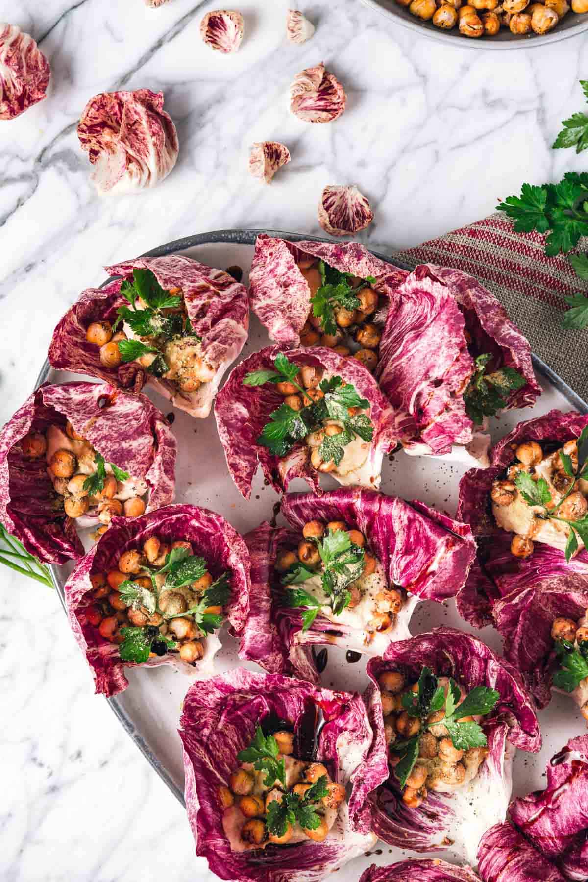 Hummus stuffed lettuce wraps on a platter.