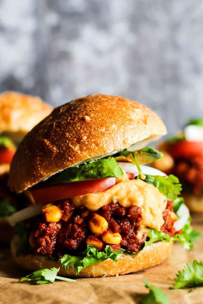Vegan mini burgers on a cutting board.