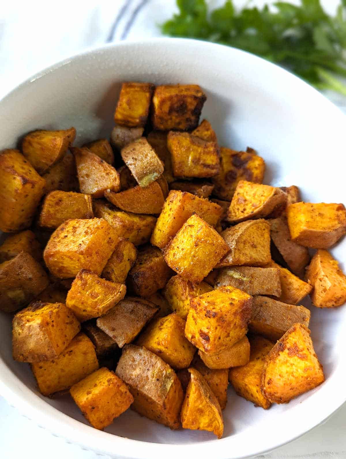 Air fried sweet potato cubes in a bowl.