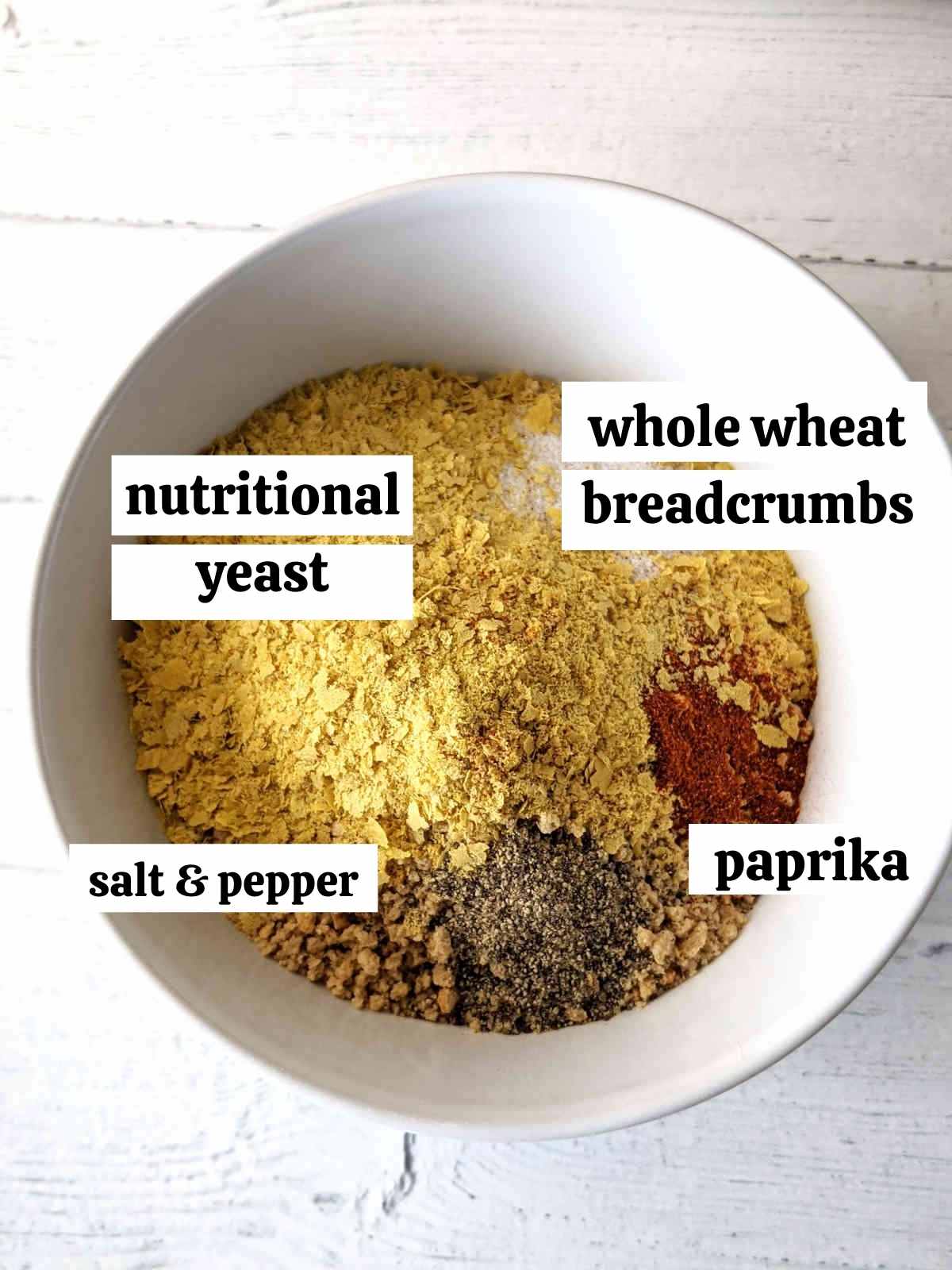 Breadcrumb topping ingredients measured an labelled in a small bowl.