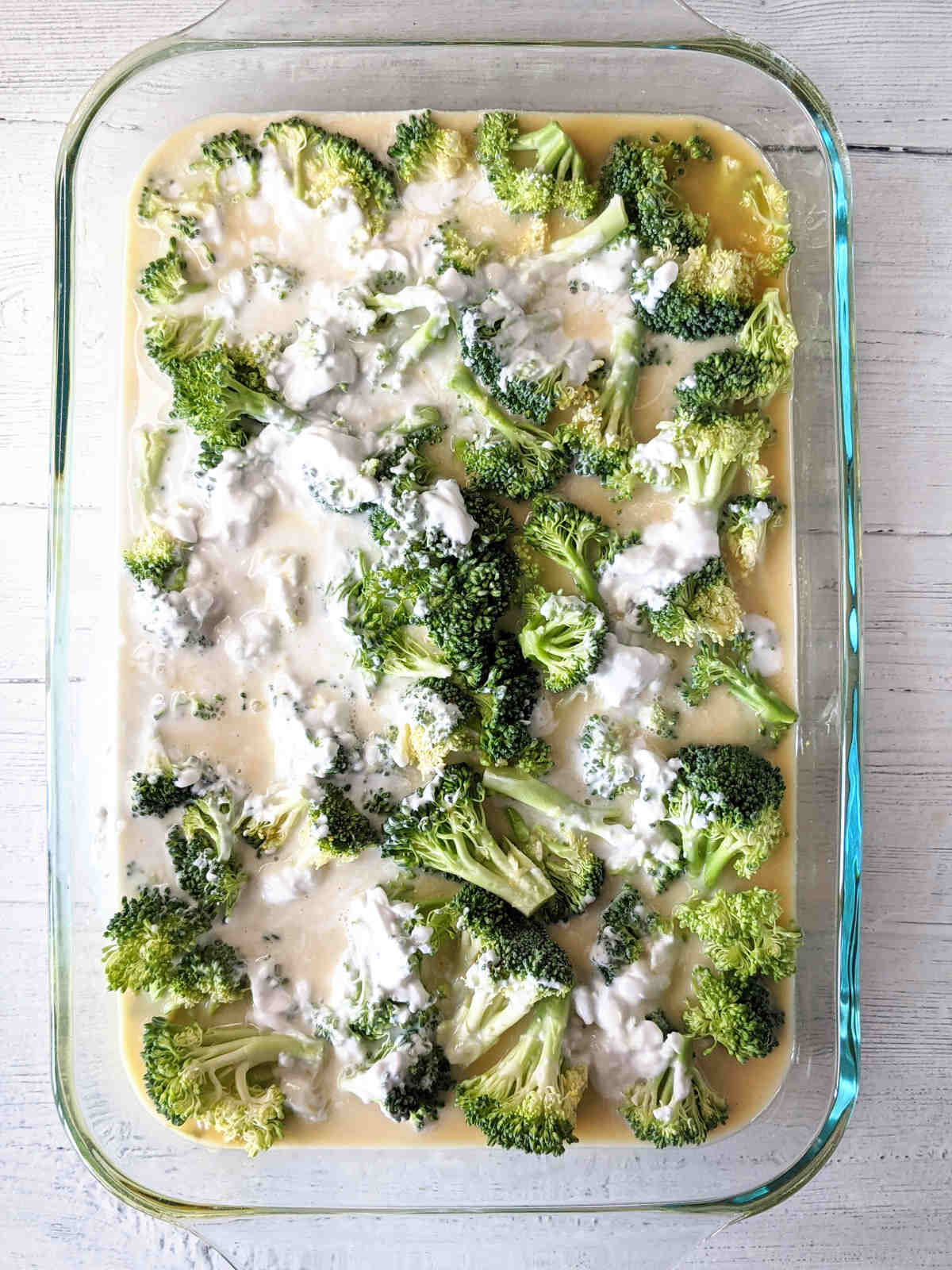 Coconut milk added to the broccoli rice casserole dish.