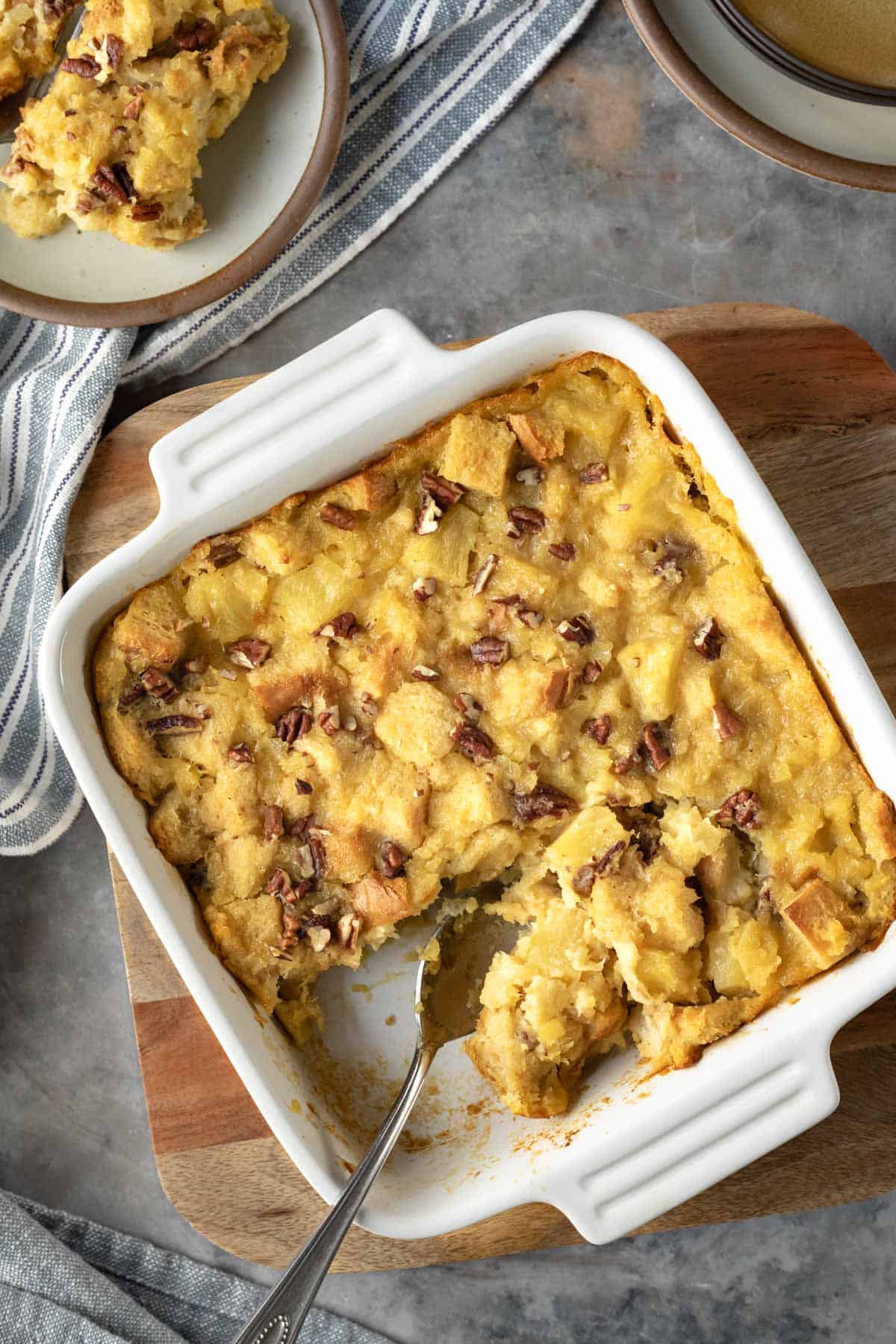 Vegan pineapple stuffing in a casserole dish topped with chopped nuts.