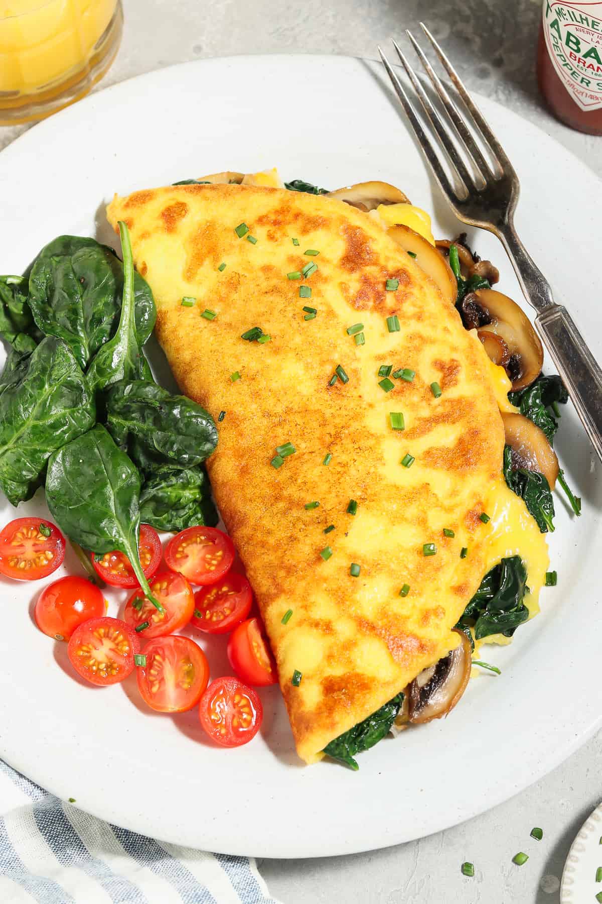 Vegan Just Egg omelet stuffed with spinach and mushrooms.