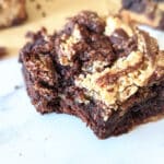 Slice of brownie blondie with a bite missing.