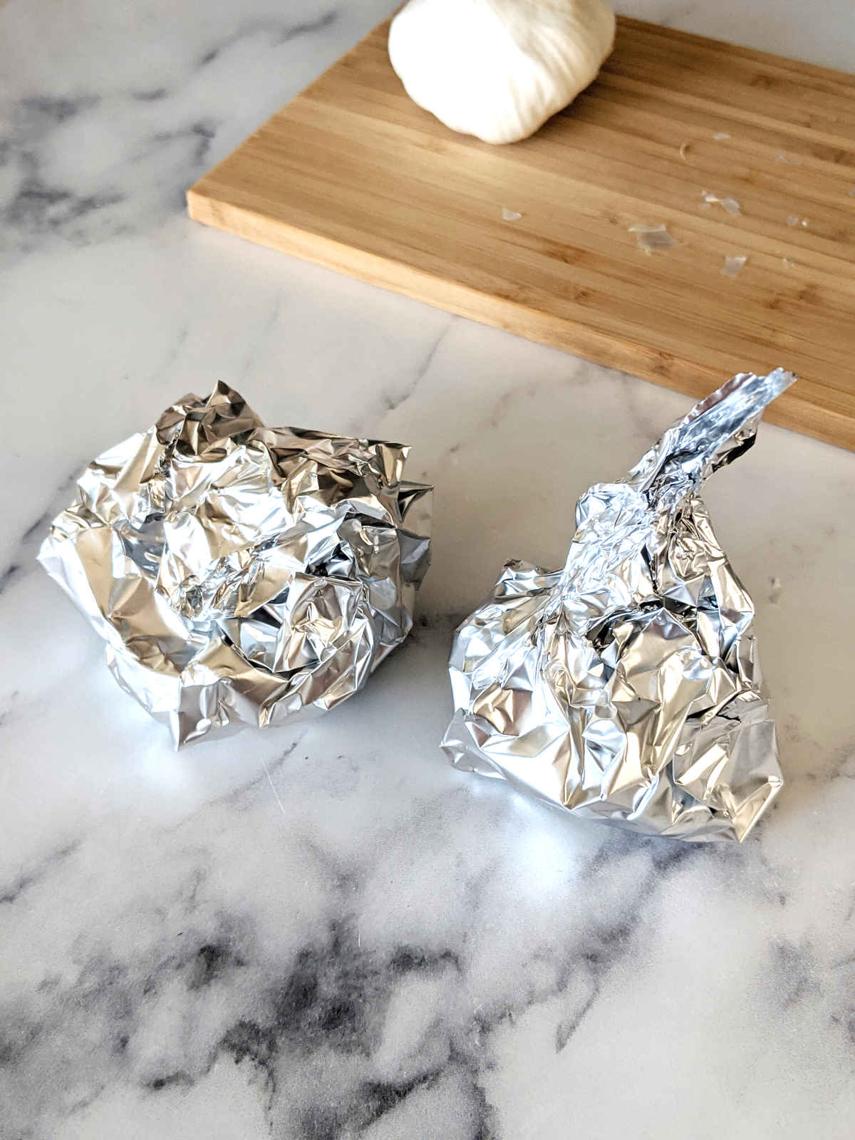 Garlic bulbs wrapped in foil.