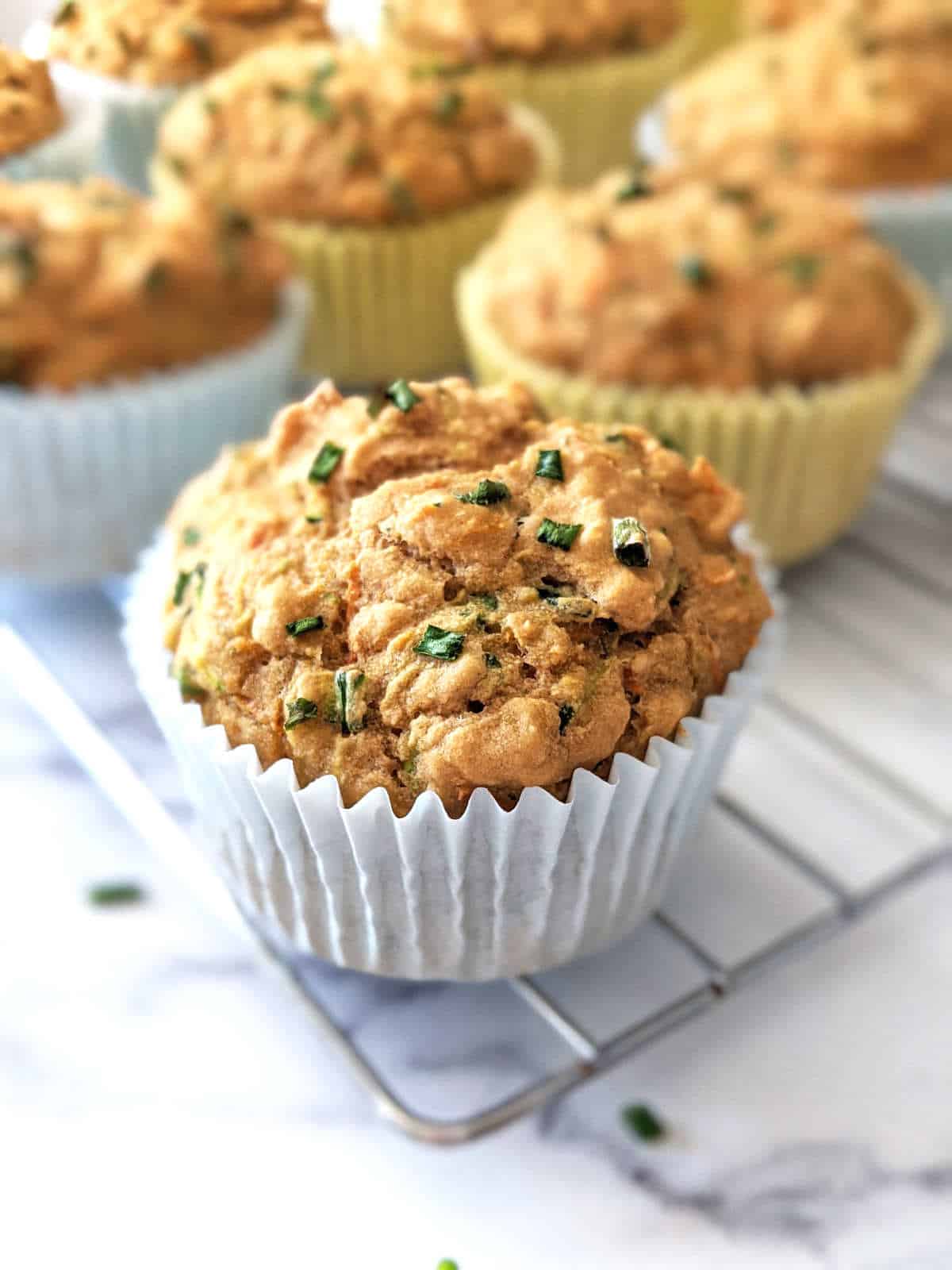 Savory vegan muffins sitting on a cooling rack.