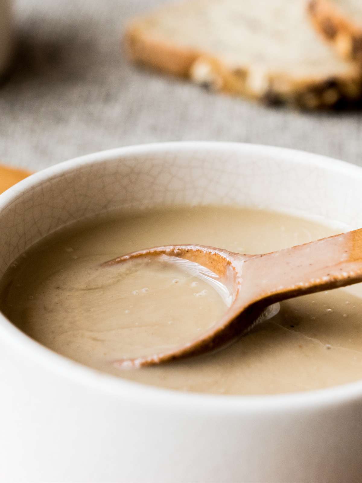 Tahini in a bowl with a spoon.