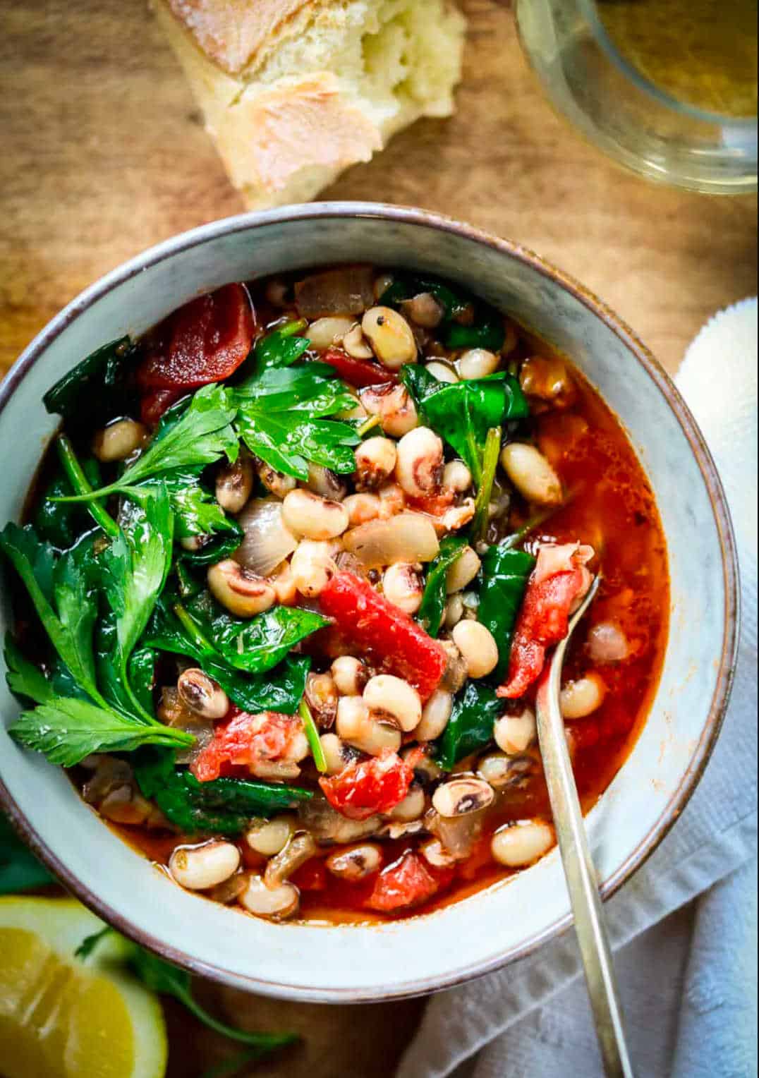 Bowl of black eye pea stew with a spoon.