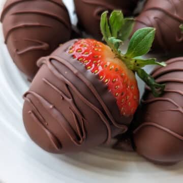 Vegan chocolate covered strawberries on a plate.