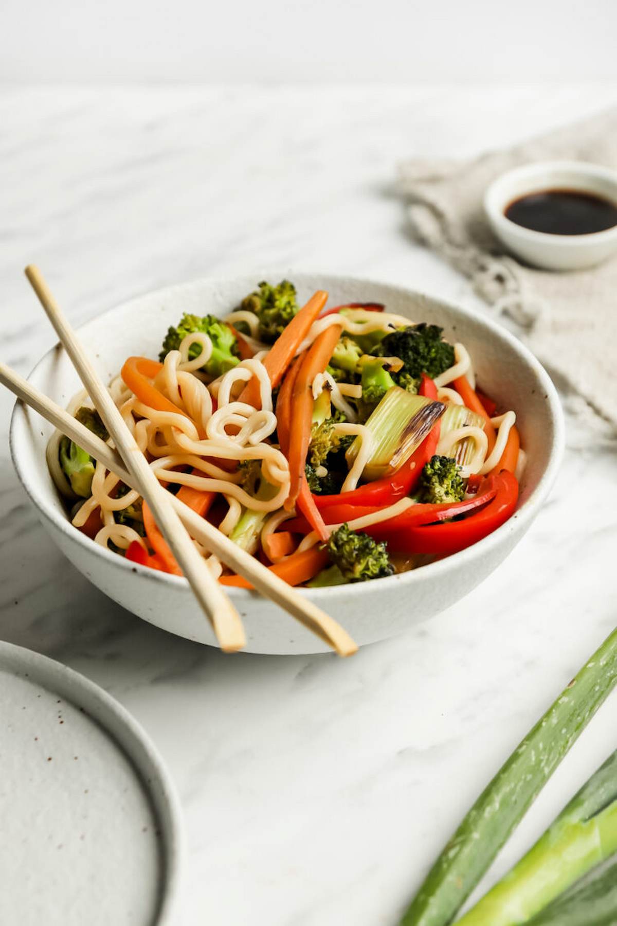 Bowl of veggie ramen with chopsticks.