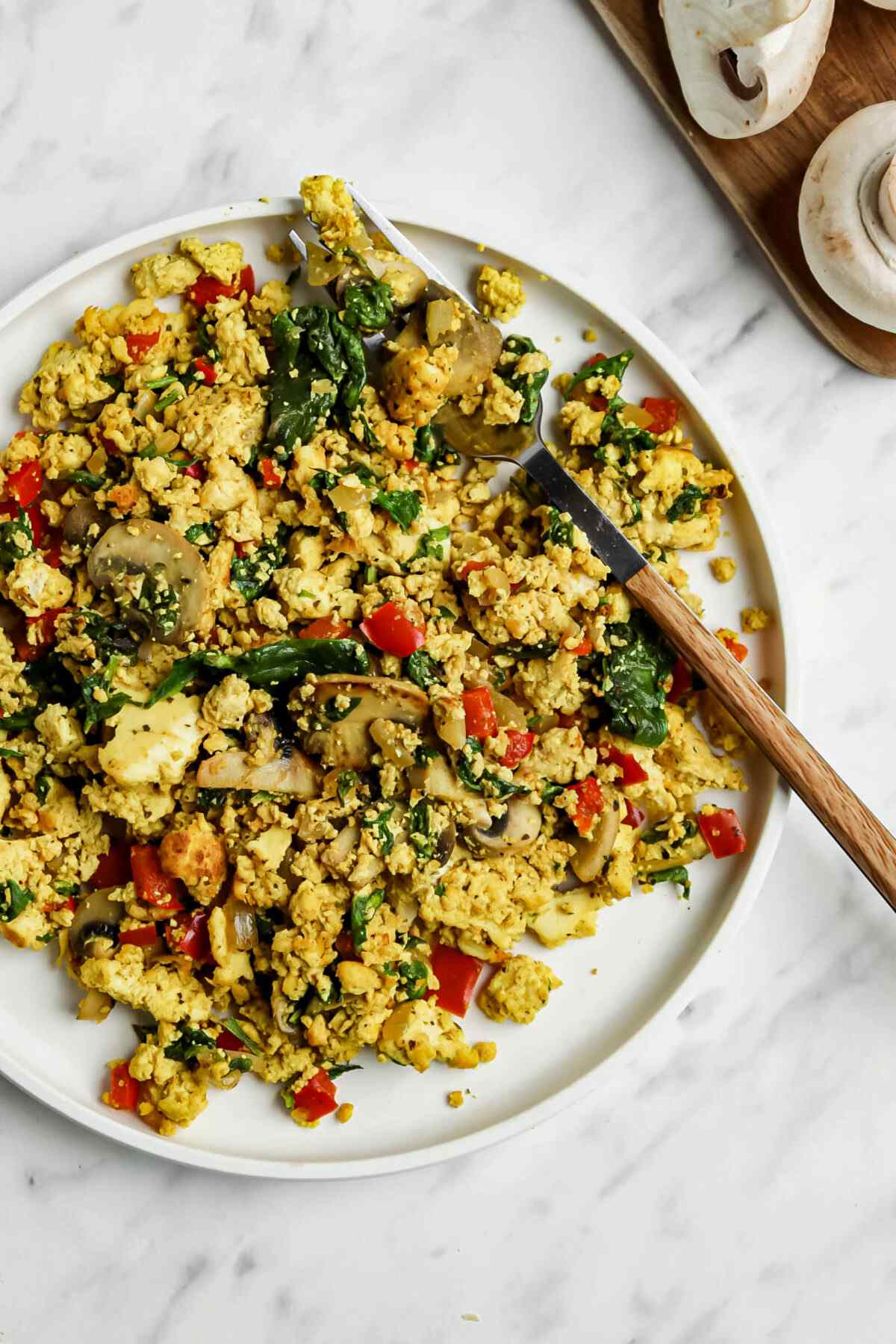 Curried tofu scramble of a plate with a fork.