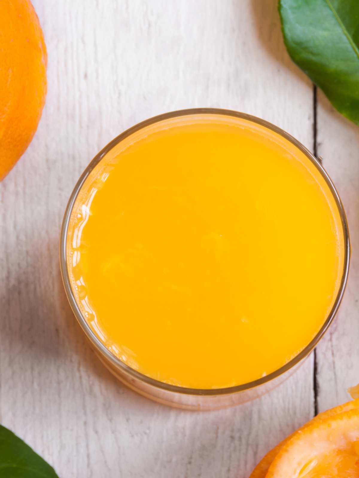 An overhead view of a glass of orange juice.