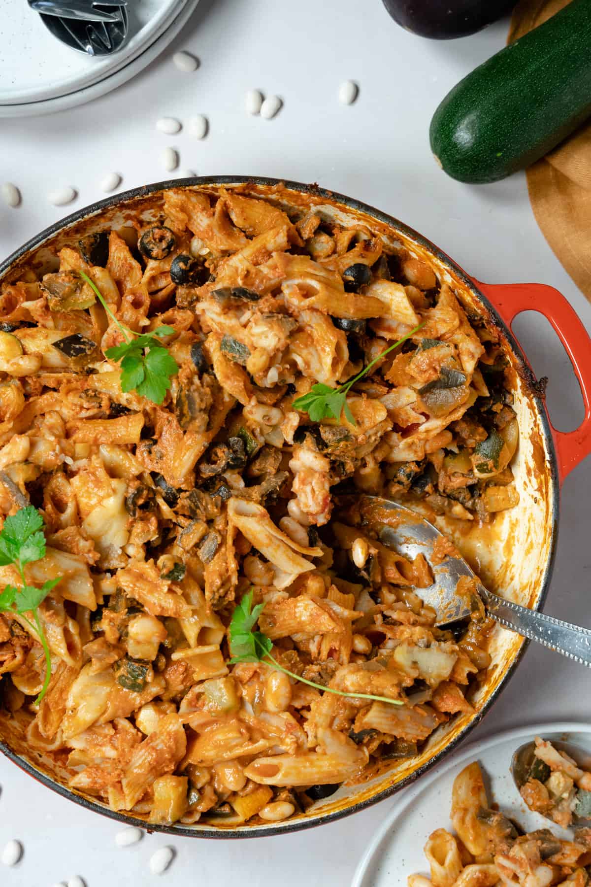 Bowl of vegan pasta bake topped with fresh herbs.