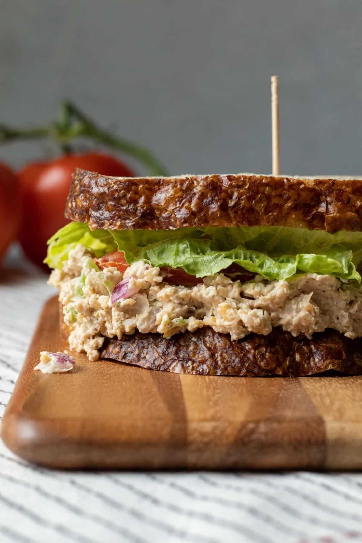 A vegan tuna salad sandwich on a cutting board.