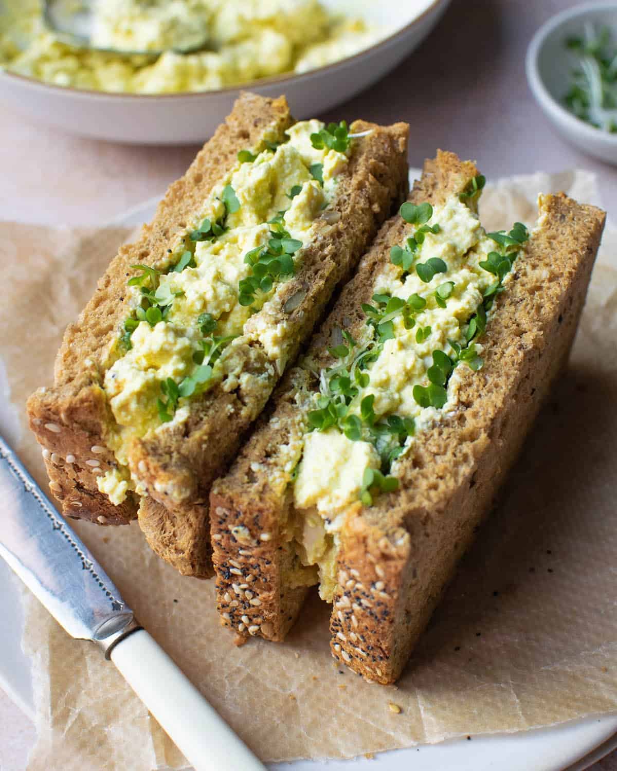 Vegan egg mayo sandwich sliced in half.