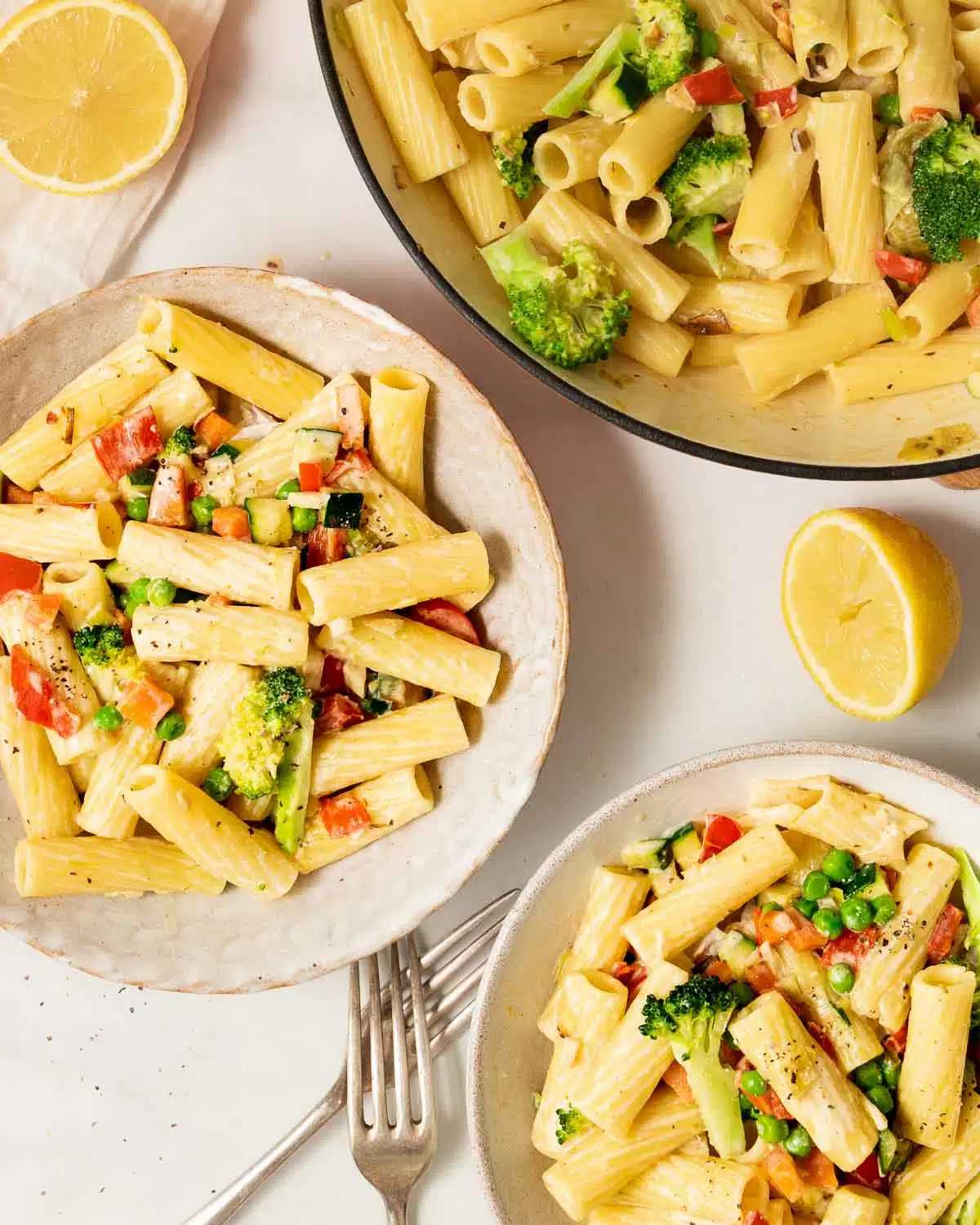 Bowls of creamy vegetable pasta.