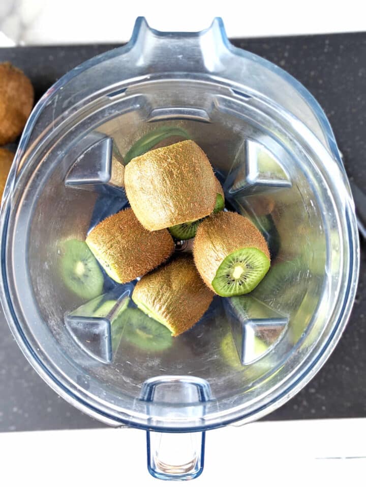 Sliced kiwi in a blender.