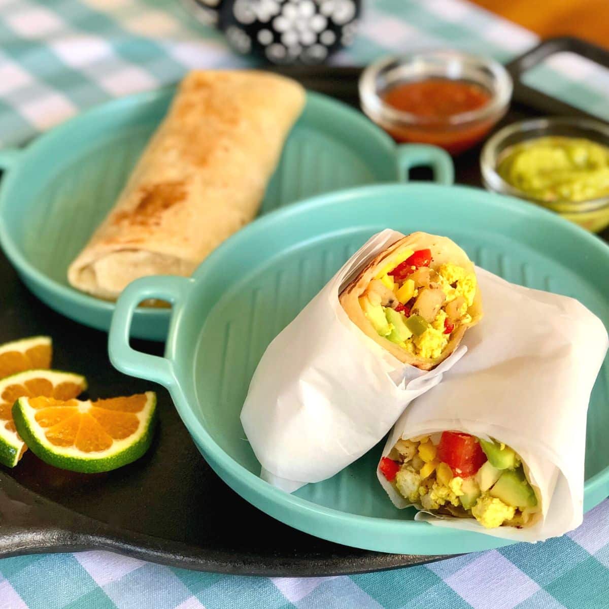 California breakfast burrito sliced in half on a plate.