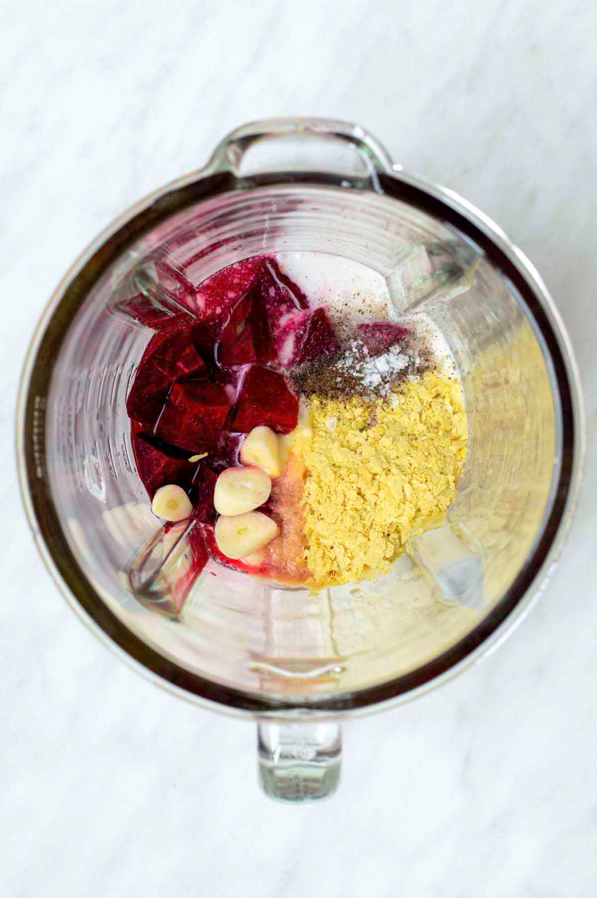 Ingredients for beet sauce added to a blender.